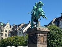 The hard workers ponder the statue of Bishop Absalon, the city's legendary founder rearing up on his noble steed above them