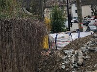 The materials for the paving of certain areas of the village (mostly up Rue Droite) were dumped against La Cachette's flood damaged fence. This added to the damage.